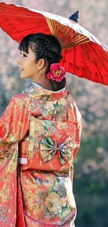 Japanese woman in kimono with red umbrella amidst cherry blossoms.