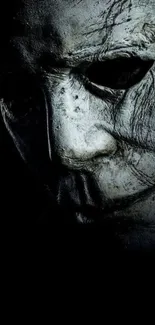 Dark textured mask on black background, mysterious and eerie feel.