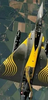 Aerial view of jet fighter displaying sleek design and vibrant yellow accents.