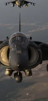 Two jet fighters flying in formation, aerial view.