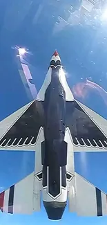 Jet fighter flying in clear blue sky with bright sunlight reflection.