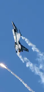 Jet fighter with trail in blue sky wallpaper.