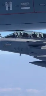 Jet fighter refueling mid-air, cockpit view.