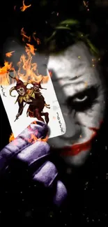 Mobile wallpaper of a Joker holding a burning playing card, set against a dark background.