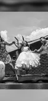 Black and white wallpaper of a joyful family jumping.