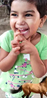 Smiling child in green shirt with horse.