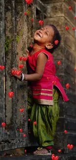 Adorable child smiling by a rustic wall in vibrant clothing.