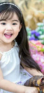 Joyful child smiling in floral background.