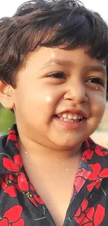 Smiling child in a green park setting.