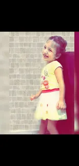 Joyful child in colorful dress with textured backdrop.