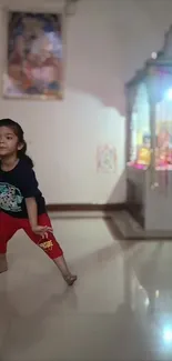 A child joyfully playing indoors with a colorful background.