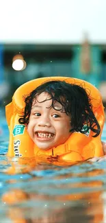 Smiling child in an orange life vest swimming in a pool on a sunny day.