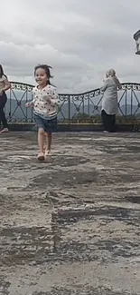 Child joyfully running in scenic outdoor setting.