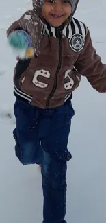 Child joyfully playing in snowy winter scene.