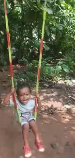 Child joyfully swinging in a lush green environment.