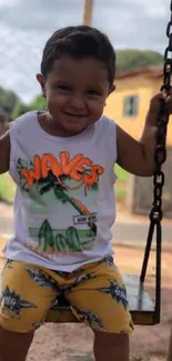 A smiling child swinging joyfully at a playground.