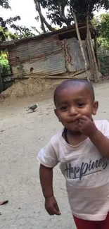 Smiling child in a rustic outdoor setting.