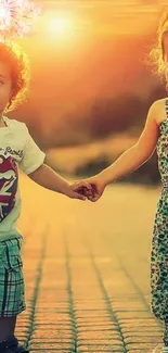 Children holding hands under a sunset with fireworks in the background.