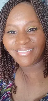 A smiling woman with curly brown hair exuding a joyful and warm expression.