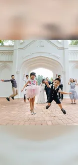 Family and kids jumping joyfully by a white arch.