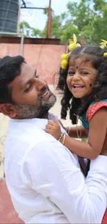 Father lifting smiling daughter outdoors, creating a joyful, colorful scene.