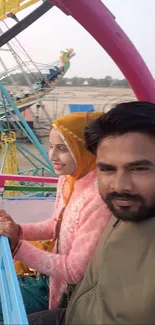 Two people enjoying a Ferris wheel ride.