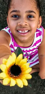 Smiling girl holding a vibrant sunflower.