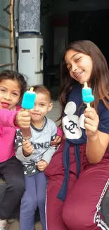 Children enjoying bright blue popsicles outdoors.