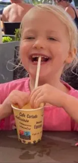 Child enjoying ice cream at an outdoor cafe scene.