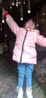 Happy child in a pink jacket with star effects in a natural setting.