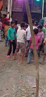 A group of children playing joyfully outdoors in an earthy setting.