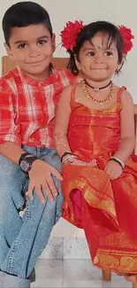 Two joyful kids in bright traditional clothing.