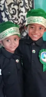 Two kids smiling in traditional attire with green hats.