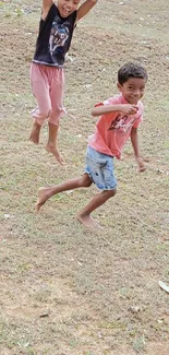 Kids jumping on a grassy field, full of joy and playfulness.