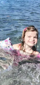 Girl smiles while playing in ocean waves on a sunny beach day.