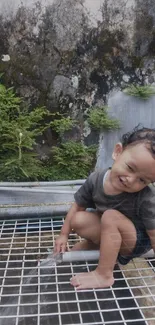 A joyful child playing outdoors near greenery.