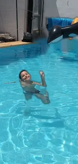 Child splashing in a sunlit swimming pool.