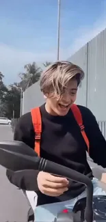 Young person joyfully riding a bike on a bright day.