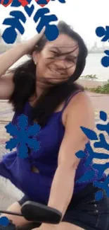 Smiling woman riding bike with blue snowflakes.