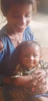 Smiling sister holding baby sibling indoors.