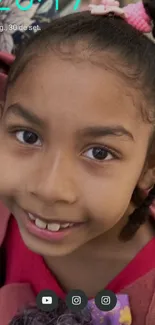 Smiling child with braids in colorful outfit, conveying joy and happiness.