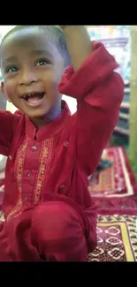 Joyful toddler in vibrant red attire, radiating happiness.