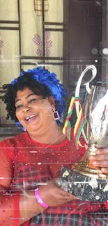 Smiling woman holding a trophy in a colorful, celebratory setting.