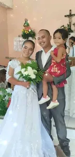 Wedding ceremony with a happy couple holding their daughter in a church setting.