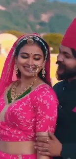 Romantic couple in vibrant traditional attire against a scenic backdrop.