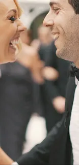 A joyful bride and groom laughing on their wedding day.