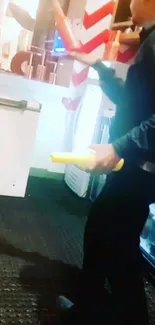 Juggler performing with vibrant red and yellow props indoors.