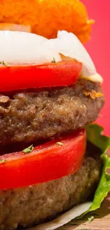 Close-up of a juicy burger with tomato and lettuce on a red background.