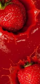 Strawberries splashing vividly on red background.