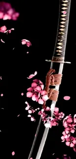 Katana with cherry blossoms on black wallpaper.